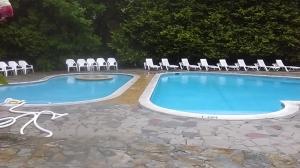 a swimming pool with chairs and a swimming pool at Villa 44 in Camelford