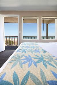 a bedroom with a bed with a view of the ocean at Seabonay Oceanfront Motel in Ocean City +20 photos
