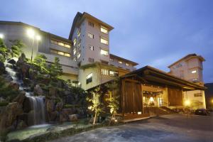 a hotel with a waterfall next to a building at Premier Resort Yuga Ise Shima in Shima