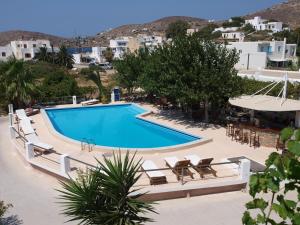 a large swimming pool with chairs and a resort at Pension Irene in Ios Chora