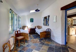 a room with two beds and a table and chairs at Moulin de Perle in Fosse