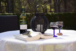 a table with a bottle of wine and two wine glasses at Ferienapartments Urlaub und Meer in Kühlungsborn