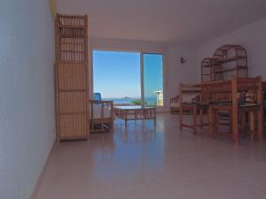 a living room with a dining table and a view of the ocean at Soling 5 in La Manga del Mar Menor