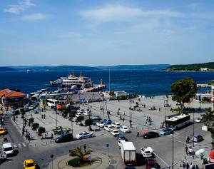 a city with a cruise ship in the water at Helen Hotel in Çanakkale