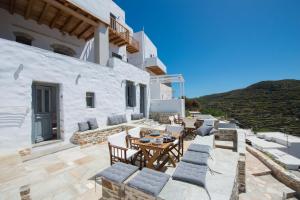 a patio with a table and chairs on a building at Athina Exquisite Houses in Kastron