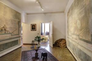 a hallway with paintings on the walls and a table at The Palace 5613 in Venice