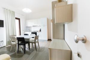 a kitchen and dining room with a table and chairs at Il Grecale case vacanza in Crotone