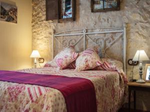 a bedroom with a metal bed with pillows at La Fuente del Pinar in Valdesimonte +50 photos