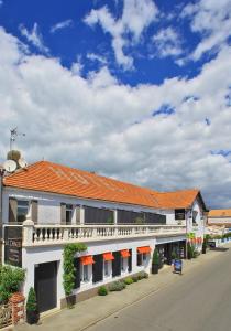 a building with an orange roof on a street at Logis Hôtel La Chaize in Noirmoutier-en-l'lle