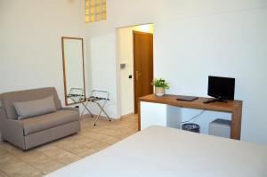 a room with a chair and a desk with a computer at Tenuta Caradonna in Lequile