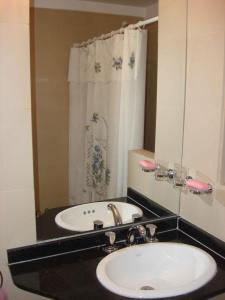 een badkamer met een wastafel en een spiegel bij Rent Apart Caballito in Buenos Aires