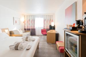 Giường trong phòng chung tại Novotel Lisboa