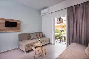 a living room with a couch and a table at IRINI STALOS Apartments in Stalos