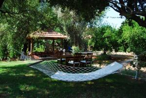 a hammock in a yard with a gazebo at Doga Apartments in Kayakoy