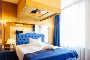a bedroom with a blue bed and a white bedspread at Hotel Village in Hamburg