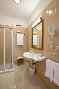 a bathroom with a sink and a shower at Hotel Centro di Spiritualità Padre Pio in San Giovanni Rotondo
