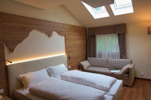 Кровать или кровати в номере Botton d'Oro delle Dolomiti +42 фотографии