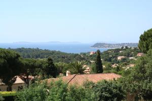 a view of a town with trees and the ocean at Hotel La Cigale in La Croix-Valmer