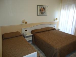 Postel nebo postele na pokoji v ubytování Hotel Riviera