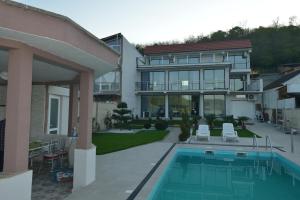 a house with a swimming pool in front of it at Casa Doma Orsova in Orşova +90 photos