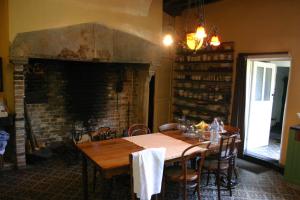 a dining room with a table and a fireplace at B&B De Sterre in Bruges