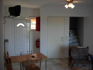 a room with a table and a door and a staircase at Gouna's Aparts in Xi