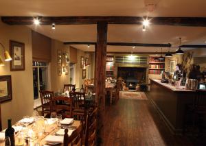 a dining room with tables and chairs in a restaurant at The White Hart Hotel in Hingham