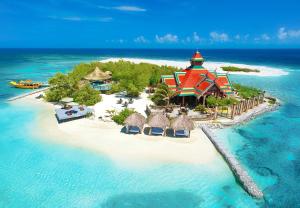 an island in the ocean with a resort on a beach at Sandals Royal Caribbean All Inclusive Resort & Private Island - Couples Only in Montego Bay