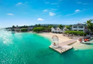 an aerial view of a beach with a pier at Sandals Royal Caribbean All Inclusive Resort & Private Island - Couples Only in Montego Bay