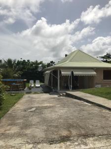 a house with a garage with a roof at Villa Kapiopa in Sainte-Anne