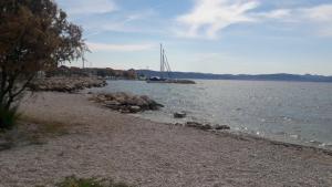 a boat is docked on the shore of a body of water at Apartments A&A in Bibinje