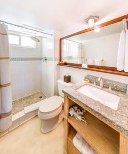 a bathroom with a toilet and a sink at Bimini Big Game Club Resort & Marina in Alice Town