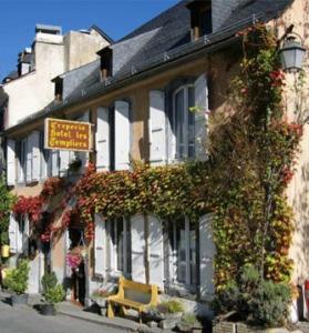 a building with plants growing on the side of it at Hôtel Les Templiers in Luz-Saint-Sauveur