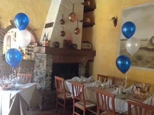 a table with blue and white balloons in a room at Agriturismo Barcola in Grandola ed Uniti