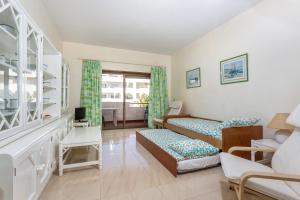 a bedroom with two beds and a living room at Andorinha 2 bedroom apart-close to the sea-Algarve in Porches