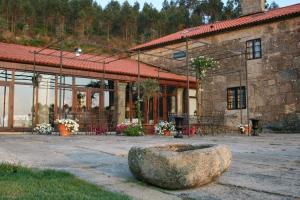 a building with a large rock in front of it at Casa Grande Do Bachao in Santiago de Compostela