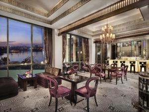 a living room with a table and chairs at Fairmont Nile City in Cairo