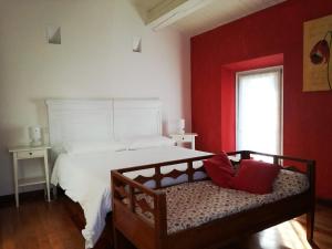 a bedroom with a bed and a bench in it at Agriturismo Morattina in Castrocaro Terme
