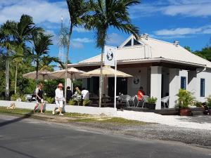 a group of people walking in front of a house at Sunset Quay in Rarotonga