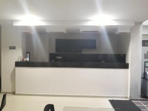 a kitchen with a counter with lights on it at Hotel Valle de Beraca in Cúcuta
