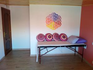 a room with a bench with colorful pillows on it at Albergue de Peregrinos La Espiral in Finisterre