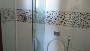 a bathroom with a toilet and a shower at Pousada Max in Currais Novos