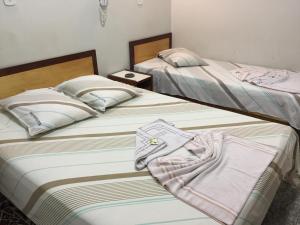 Katil atau katil-katil dalam bilik di Hotel Ferreira Viana