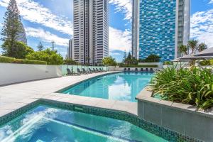 een zwembad in een stad met hoge gebouwen bij Mantra Sierra Grand in Gold Coast