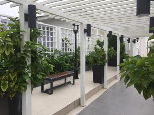 a greenhouse with benches and potted plants in it at Cameron 2Room Square @Golden Hill in Cameron Highlands