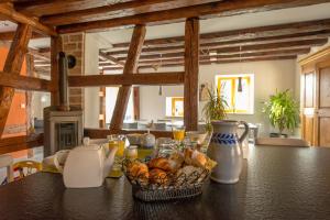 a kitchen with a table with a basket of bread at La Maison d'Emilie in Pfaffenheim