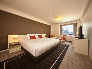 a hotel room with a bed and a television at Tokyo Prince Hotel in Tokyo +49 photos