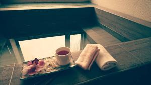a plate with a cup of coffee and a towel at Xiang Ting in Puli