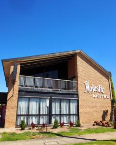 a large brick building with amusicle medical sign on it at Majestic Motel in Horsham