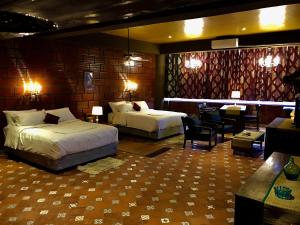 a hotel room with two beds and a bar at Golden Lotus Bangalore Boutique Suites in Bangalore